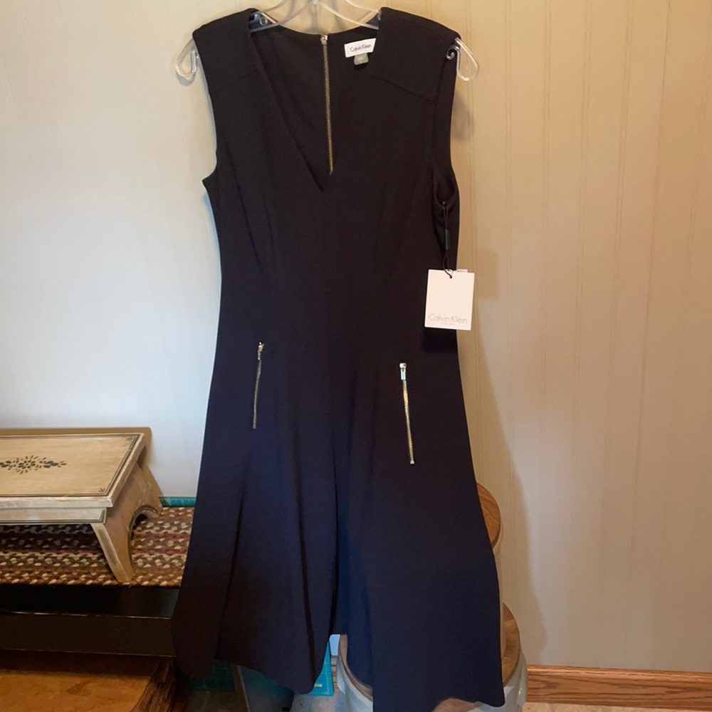 Cute black mid length dress with zipper pockets